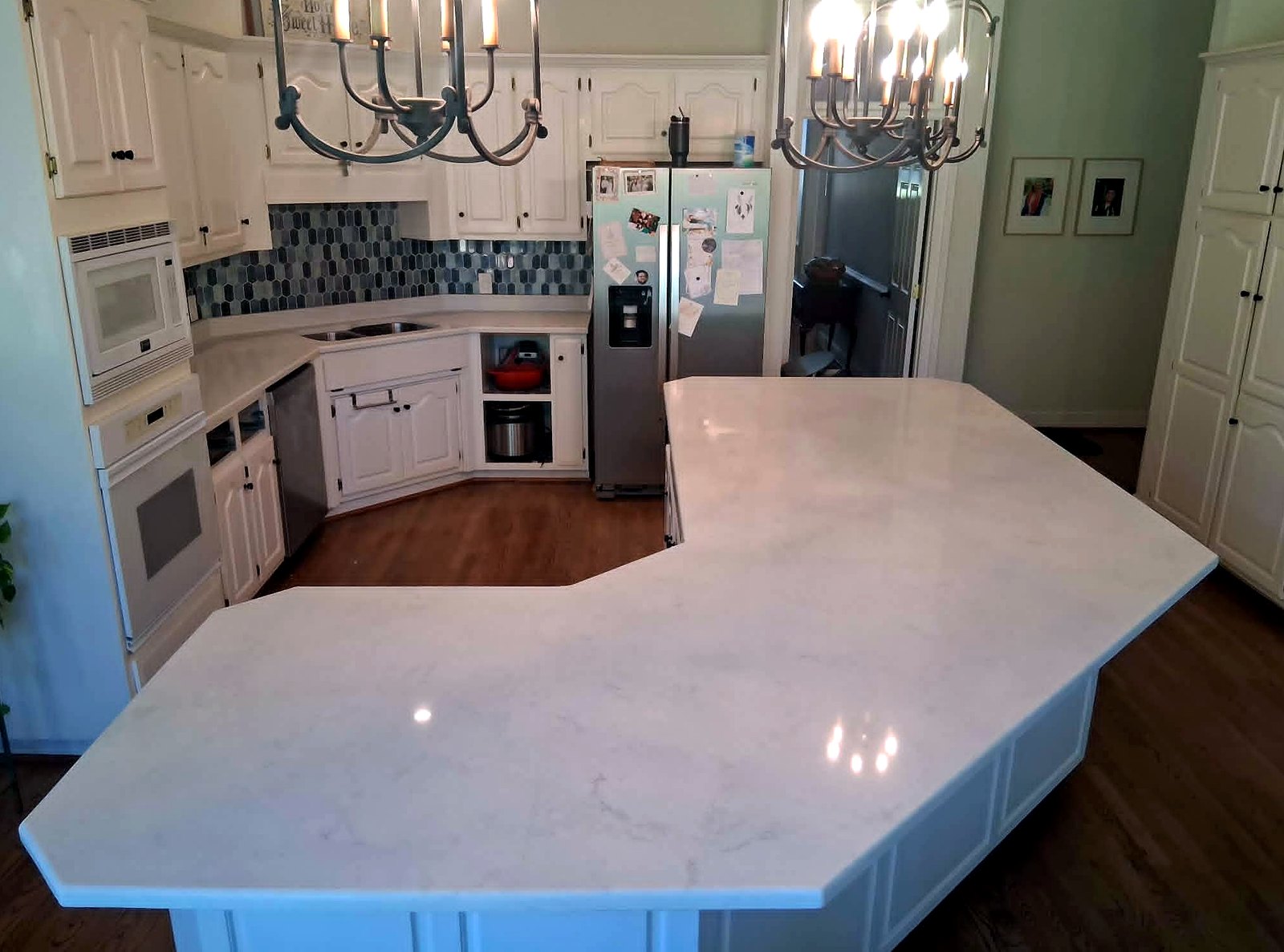 Luxury kitchen with chandeliers and marble island