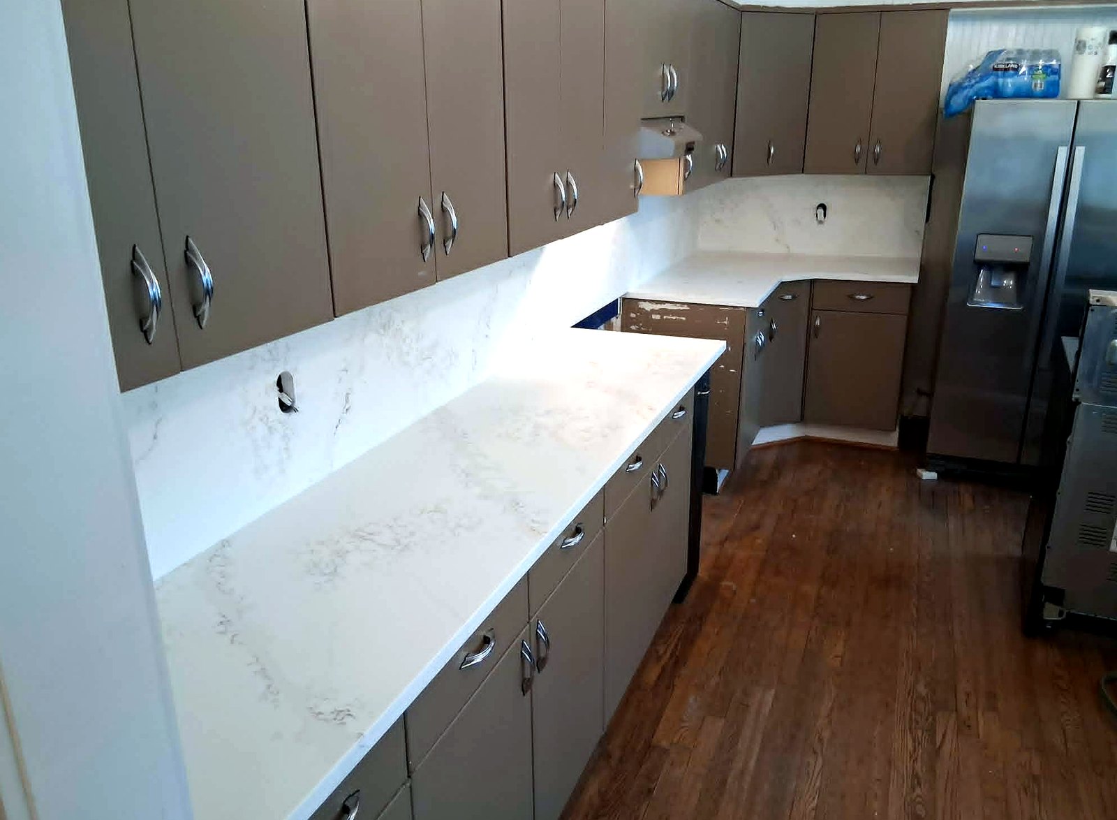 Waterfall marble island, wood cabinetry