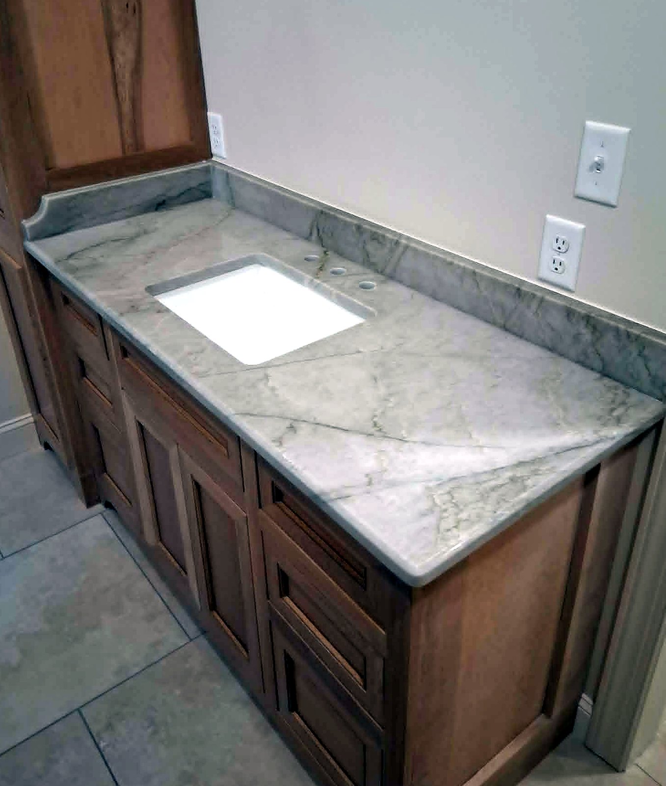 Gray marble vanity, wood cabinets
